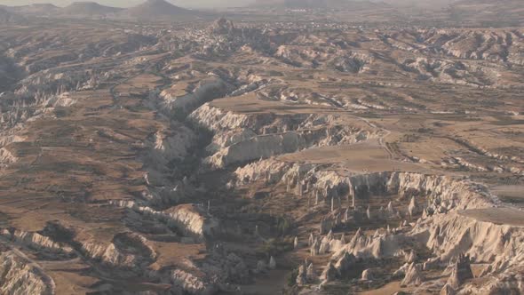 Grey Hot Air Balloon Flies Over Large Endless Rocky Cliffs