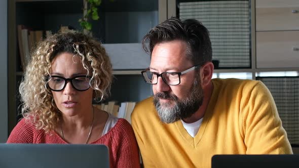 Happy adult couple work at home together with video conference call from room office