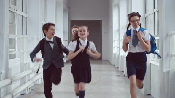 Excited Schoolchildren Running in Hallway
