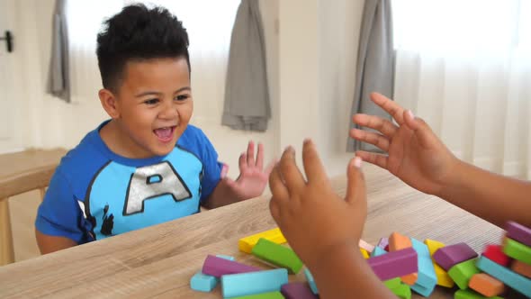 Happy Boy With Falling Wood Block Tower Game