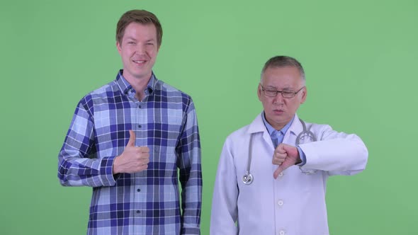 Mature Japanese Man Doctor with Young Man Having Different Opinions Together