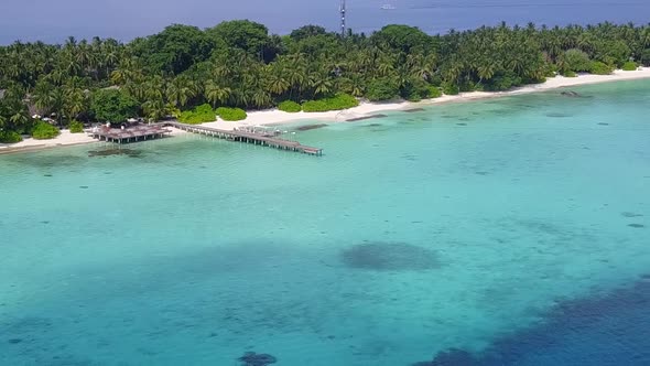 Aerial landscape of tourist beach by clear sea with sand background