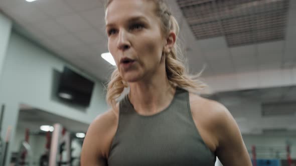 Caucasian woman doing dynamic workout at the gym. Shot with RED helium camera in 8K.