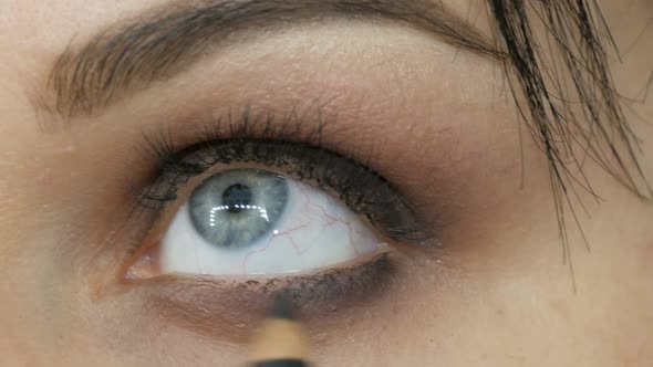 A Special Gray Brush or Pencil for Eye Makeup Applies Eye Shadow on Lower Eyelid
