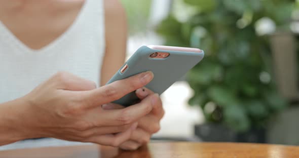 Woman typing on mobile phone at outdoor 