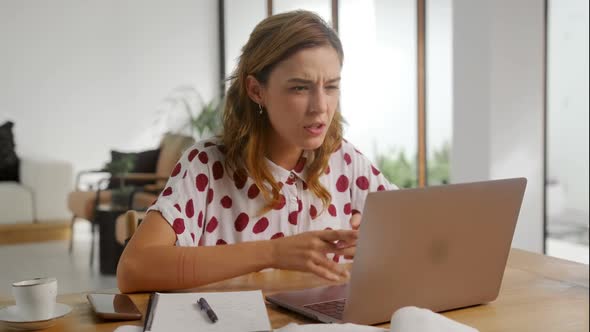Woman Using Laptop at Home Frustrated Shocked After Reading Bad Online News