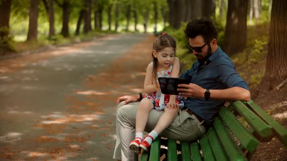 Little Cute Preschool Girl Tap Pad Screen. Daughter With Father Learning Tablet Digital Technology.