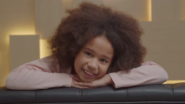 Positive Cute School Age African American Girl Looking with Cheerful Smile