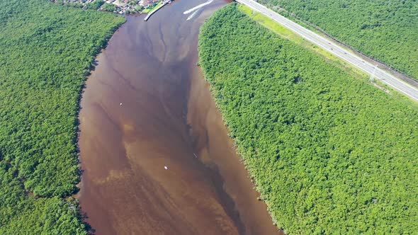 Peaceful dark river scene at coastal city of Itanhaem Sao Paulo Brazil.