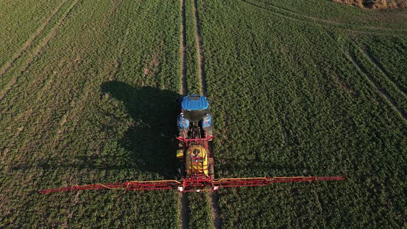 Tractor Spray Fertilizer on Agricultural Field Aerial View