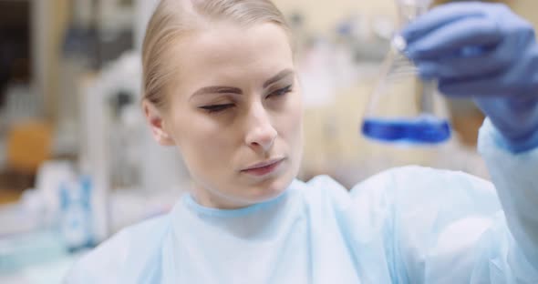 Scientist Mixing Liquid at Laboratory