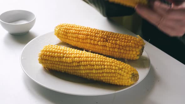 Eating Prepared Corn Cobs at the Table