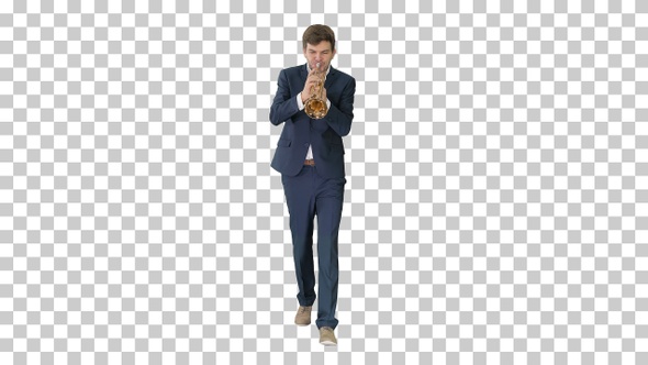 Young man in suit playing a trumpet while walking, Alpha Channel