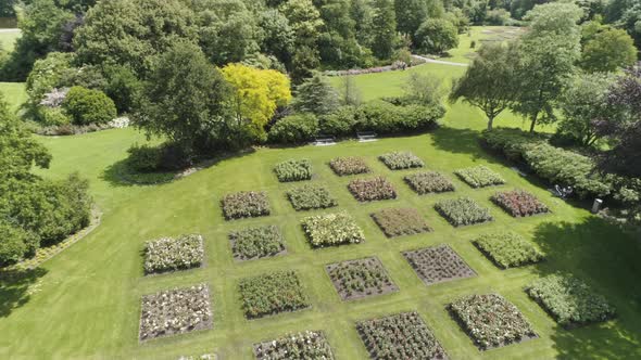 Drone Slowmotion of an Dutch Flower Garden during Spring, with lots of Flowers and Green Trees