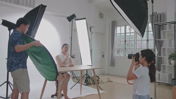 Photographer And Pretty Model Working In Studio