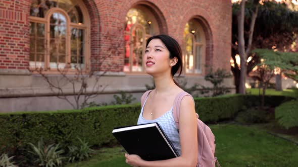 Asian female college student walking  to her class