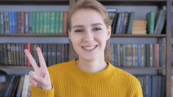 Victory Sign by Positive Young Woman