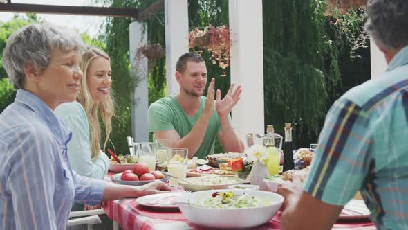 Happy family eating together at table