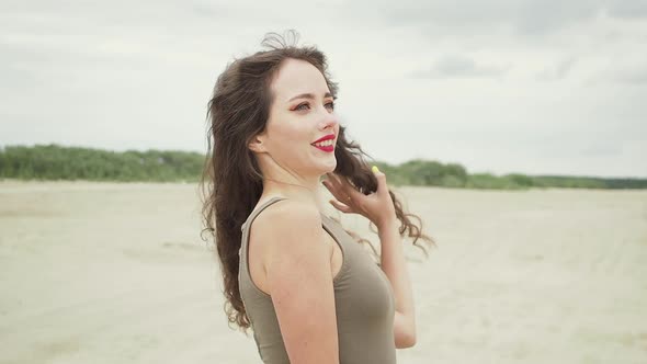 Pretty Woman Touching Hair on Beach