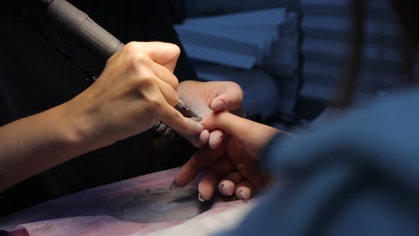 Anonymous Beautician Doing Manicure to Female Client