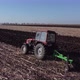 red tractor plows a field in autumn in Ukraine - VideoHive Item for Sale