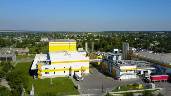 Industrial Area With Factory. Aerial view of a factory or industrial area surrounded by green fields