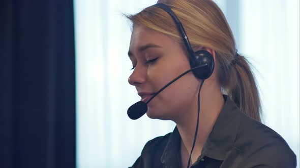Female Customer Support Operator with Headset Talking and Smiling