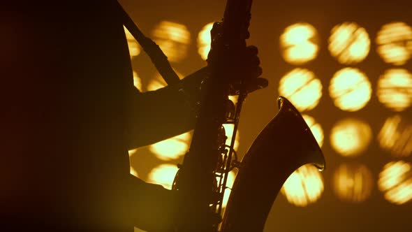 Saxophonist Silhouette Hands Playing Musical Instrument in Spotlights Close Up