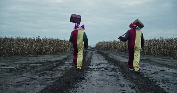 Two Scary Clowns Are Walking Along A Corn Path