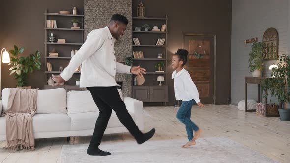 African Family Dancing in Living Room Celebrate Moving Day