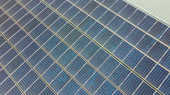 Closeup of surface of blue photovoltaic solar panels mounted on building roof for producing