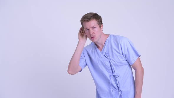 Portrait of Young Man Patient Listening and Showing Silent Gesture