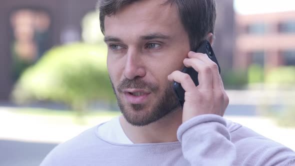 Handsome Man Talking on Phone, Negotiating in Good Mood