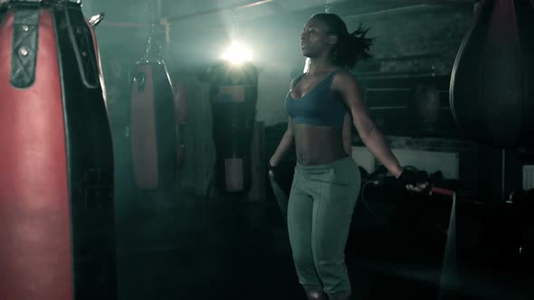 Female Boxer training with Skipping rope in Boxing club