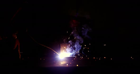 Welder working on a piece of metal