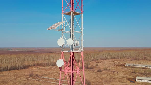 View of Metal Tower Communication with Antennas Against Sky with Horizon