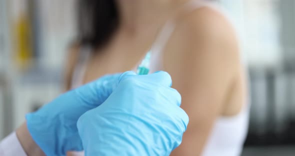 Patient Refusing to Be Vaccinated Against Covid 19 in Front of Doctor with Syringe in Hand Closeup