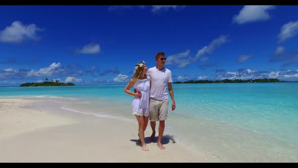 Romantic couple in love on beautiful coast beach wildlife by blue lagoon and white sand background o