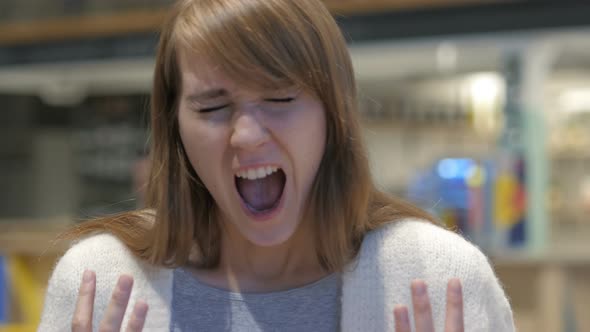 Portrait of Screaming Young Woman, Shouting in Cafe