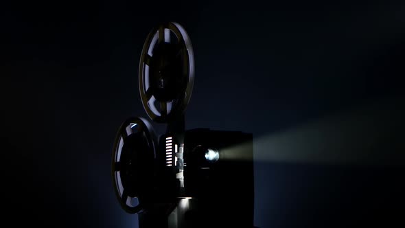 Film Projector Showing Movie in Dark Place. Light From Inside