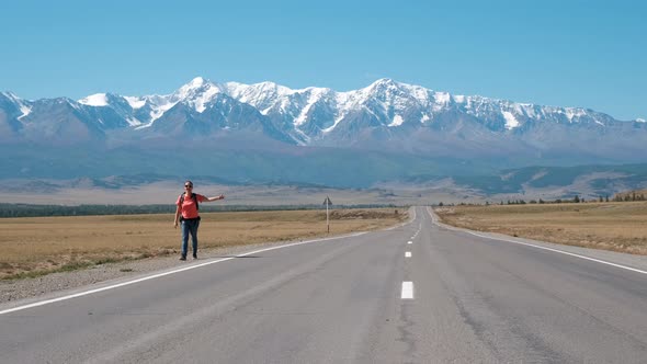 Woman with Backpack Hitchhiking on Mountain Road