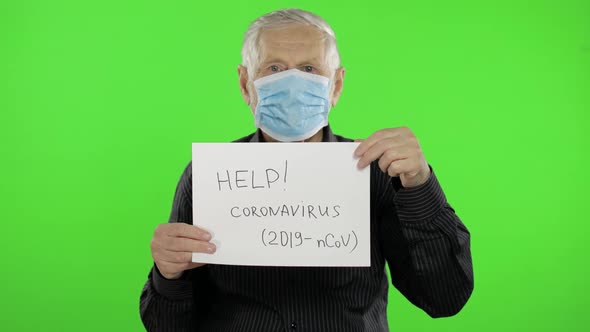 Elderly Grandfather Man in Medical Mask Show Page with Message. Coronavirus