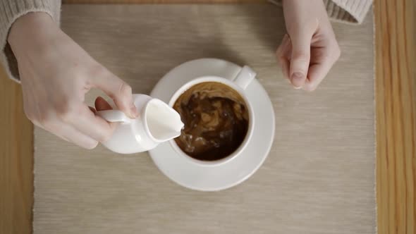 Pouring Hot Milk Into a Cup o Espresso