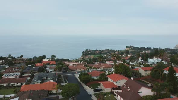 Midday drone view from a lower height and taking off slowly above one of the Palos Verdes Estates st