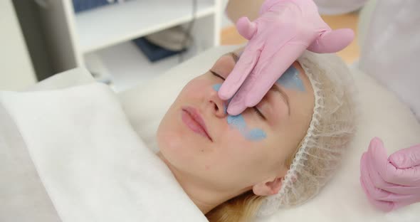 Applying A Cosmetic Mask On The Face In A Beauty Salon