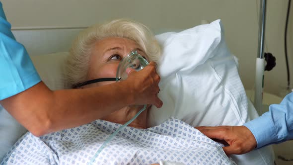 Nurse putting oxygen mask on patient