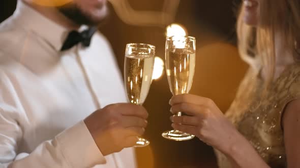 Man and Woman Clinking Glasses at Party