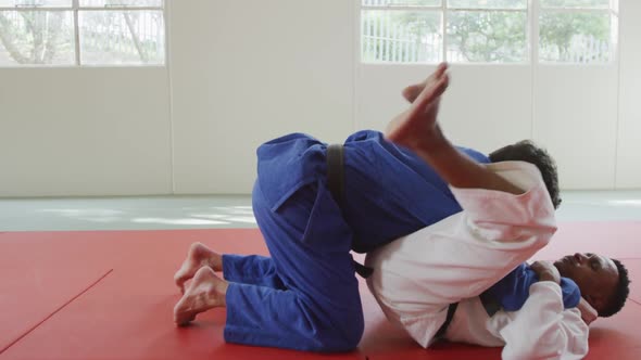 Judokas fighting and immobilizing on the ground