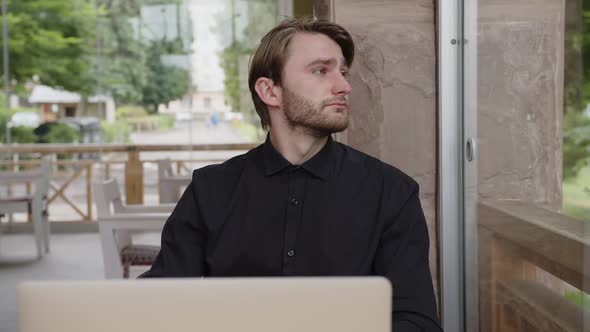 Exhausted Programmer Sitting at the Table After a Busy Day