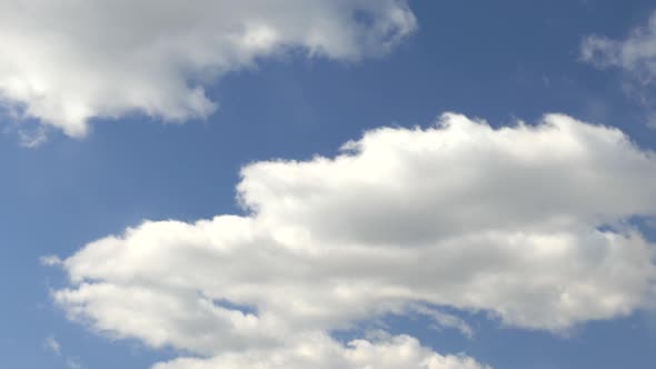 White Clouds Move Across a Beautiful Blue Sky. Nice Sunny Weather.